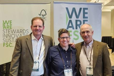 Three representatives stand together smiling in front of FSC banners reading “We Are FSC” and “We Are Stewards, Innovative, Sustainable,” during the California Forestry Association’s annual meeting in Sacramento.