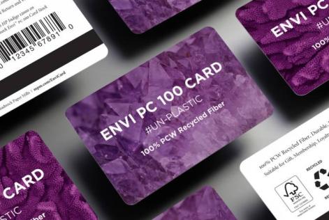 Stack of purple ENVI PC 100 cards made from 100% post-consumer recycled fiber, featuring FSC and recycling symbols.