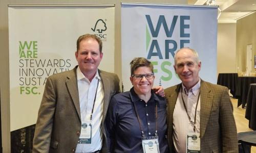 Three representatives stand together smiling in front of FSC banners reading “We Are FSC” and “We Are Stewards, Innovative, Sustainable,” during the California Forestry Association’s annual meeting in Sacramento.