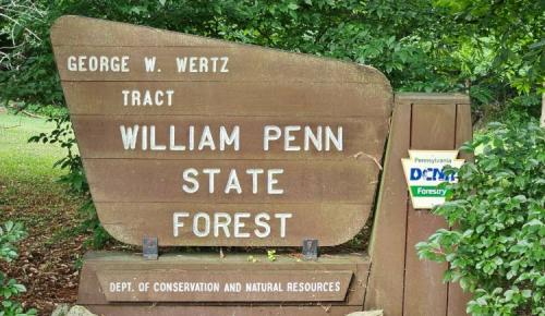 Wooden sign for William Penn State Forest in Pennsylvania.
