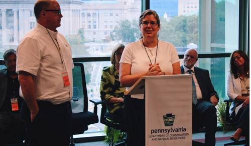 Speaker addresses the audience at a DCNR podium during a ceremony.