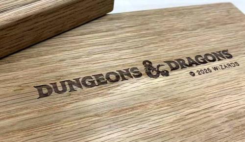 A close-up of the Dungeons & Dragons logo laser-engraved onto the surface of the wooden vault.