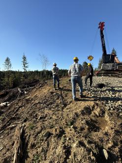 people watching harvest on steep hillside